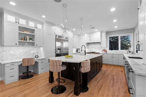 a large kitchen with stainless steel appliances kitchen island granite countertop a sink and cabinets