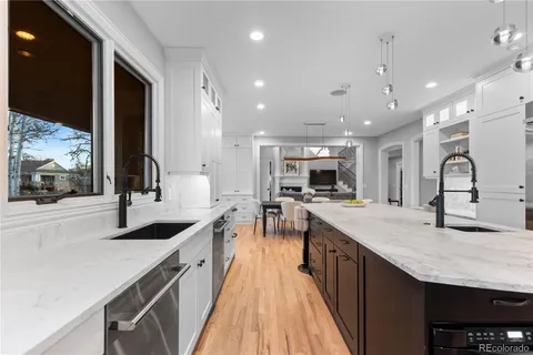a large kitchen with kitchen island a sink appliances and a counter space