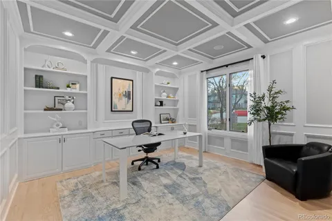 a living room with furniture a window and a potted plant
