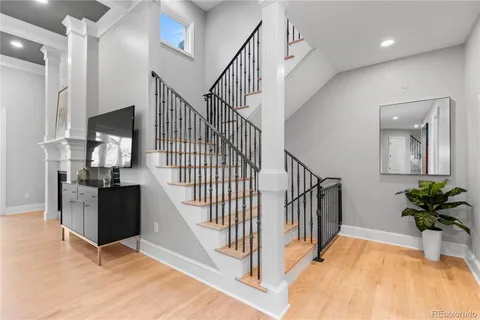 a view of entryway and hall with wooden floor
