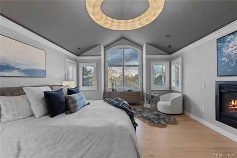 a spacious bedroom with a bed and glass windows