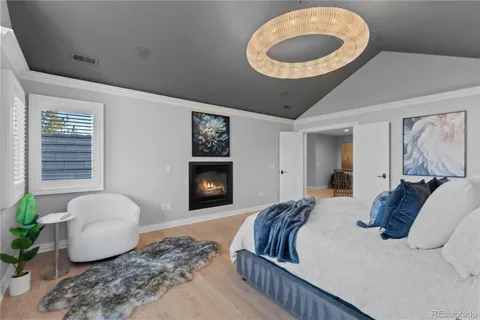 a bedroom with a bed and a painting on the wall