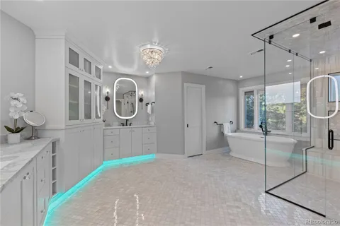 a large white kitchen with a large window and stainless steel appliances