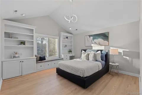 a bedroom with a large bed and a window