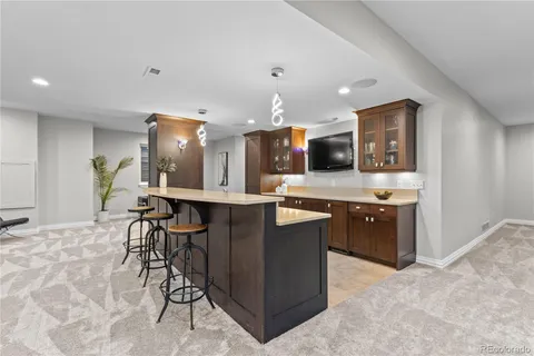 a kitchen with stainless steel appliances kitchen island granite countertop a refrigerator and a stove top oven