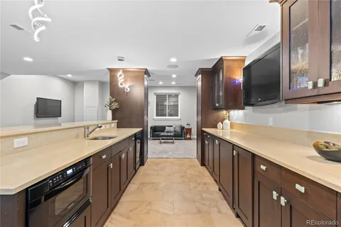 a large kitchen with stainless steel appliances kitchen island granite countertop a large counter top and sink