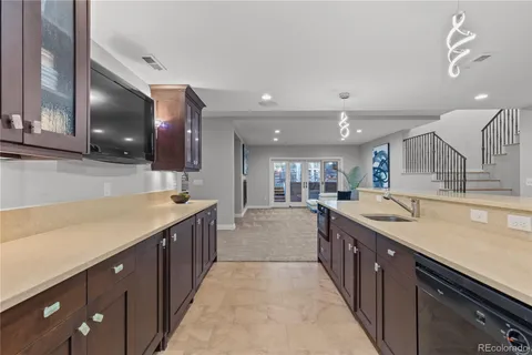 a bathroom with a granite countertop sink and a large mirror