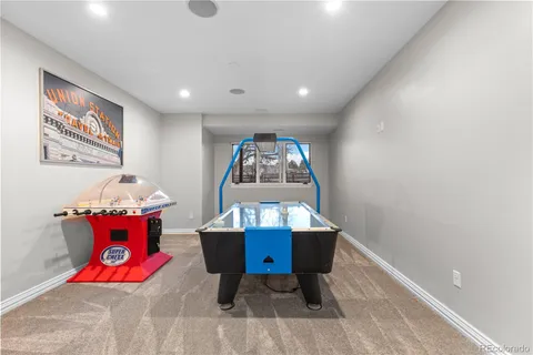 a living room with furniture and air hockey table