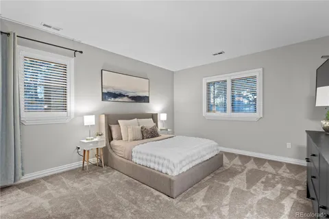 a bedroom with a bed lamp and a window