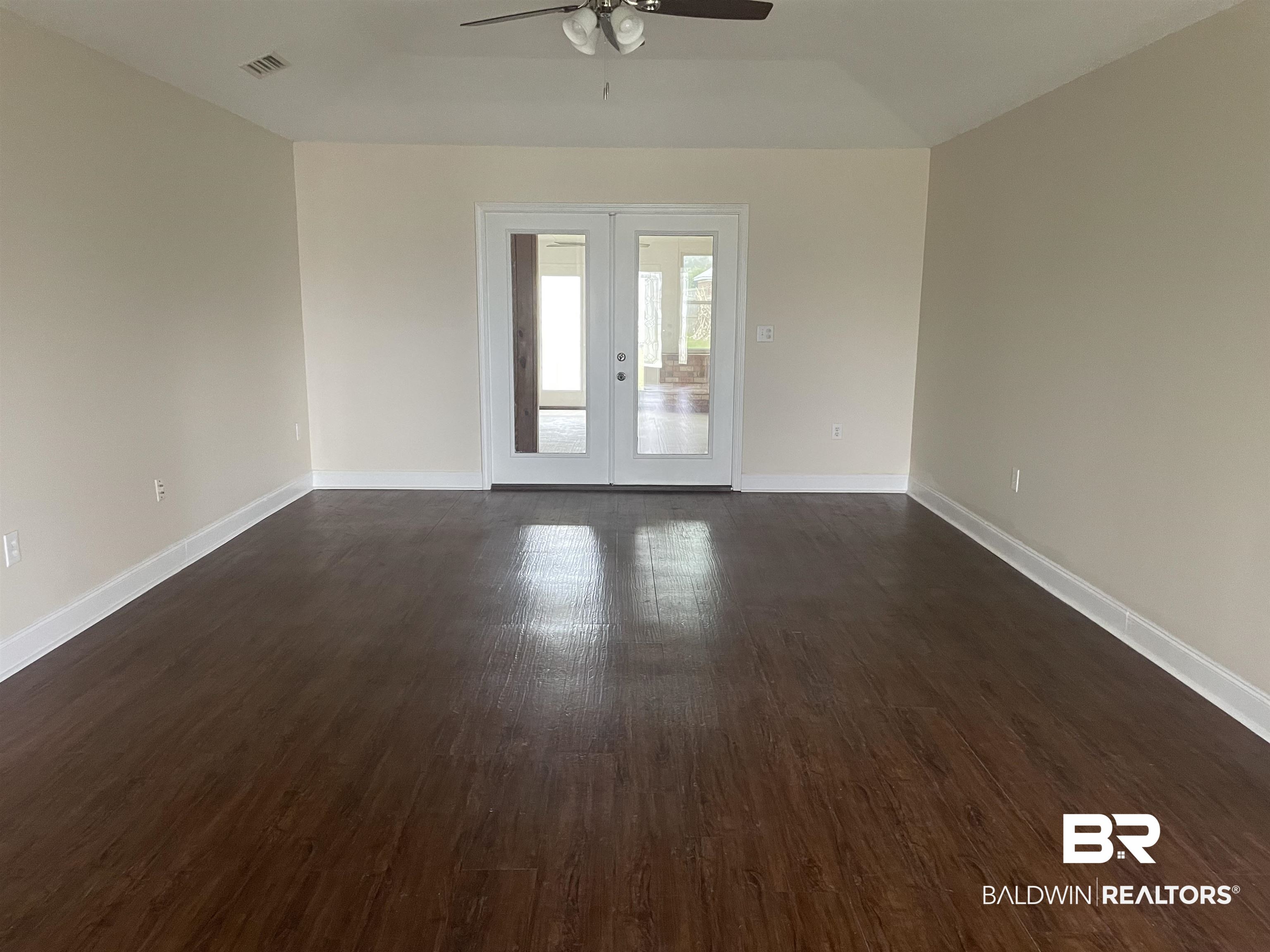 23575 Fountain Street Robertsdale, AL 36567 - Photo 12 of 19 Unfurnished room featuring french doors, dark wood-style flooring, visible vents, and baseboards