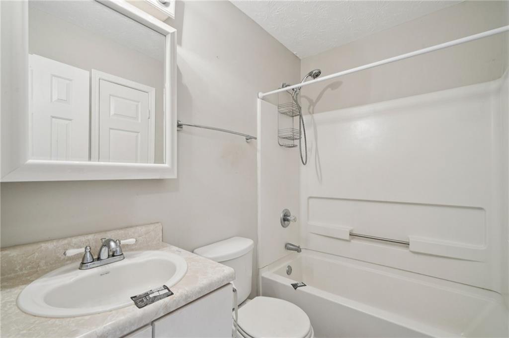 1443 Pebble Ridge Lane Hampton, GA 30228 - Photo 18 of 24 a bathroom with a sink toilet and shower