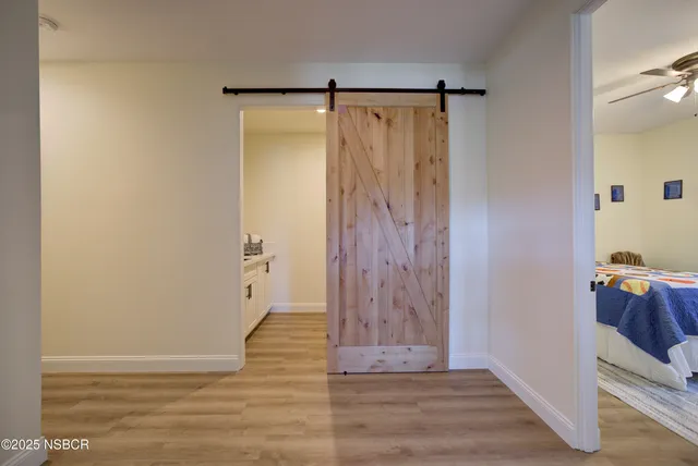 a view of walk in closet with wooden floor