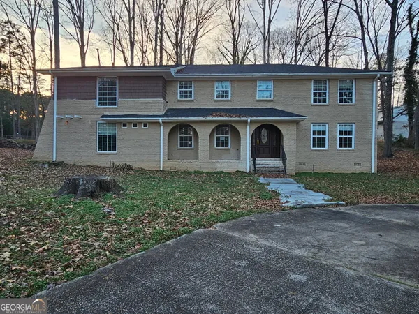 a front view of a house with garden