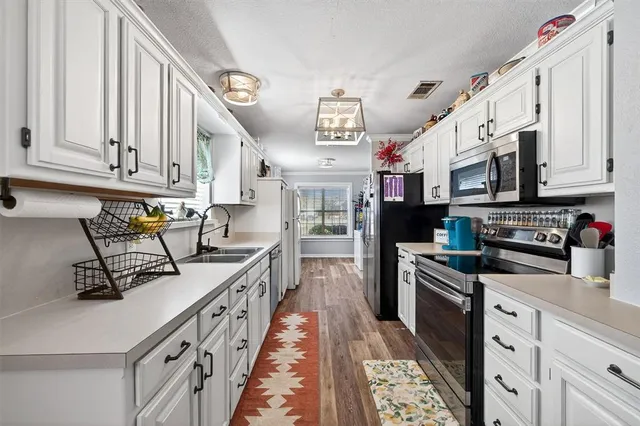 a kitchen with stainless steel appliances a stove microwave and a refrigerator