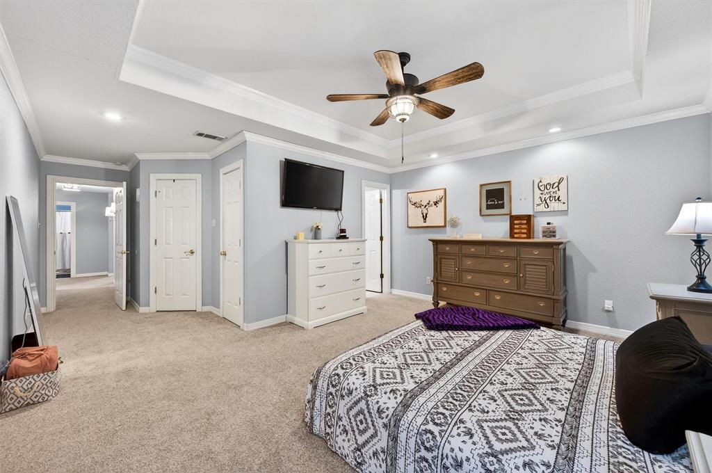 207 Gayle Circle Bells, TX 75414 - Photo 16 of 30 a bedroom with a bed and a flat screen tv