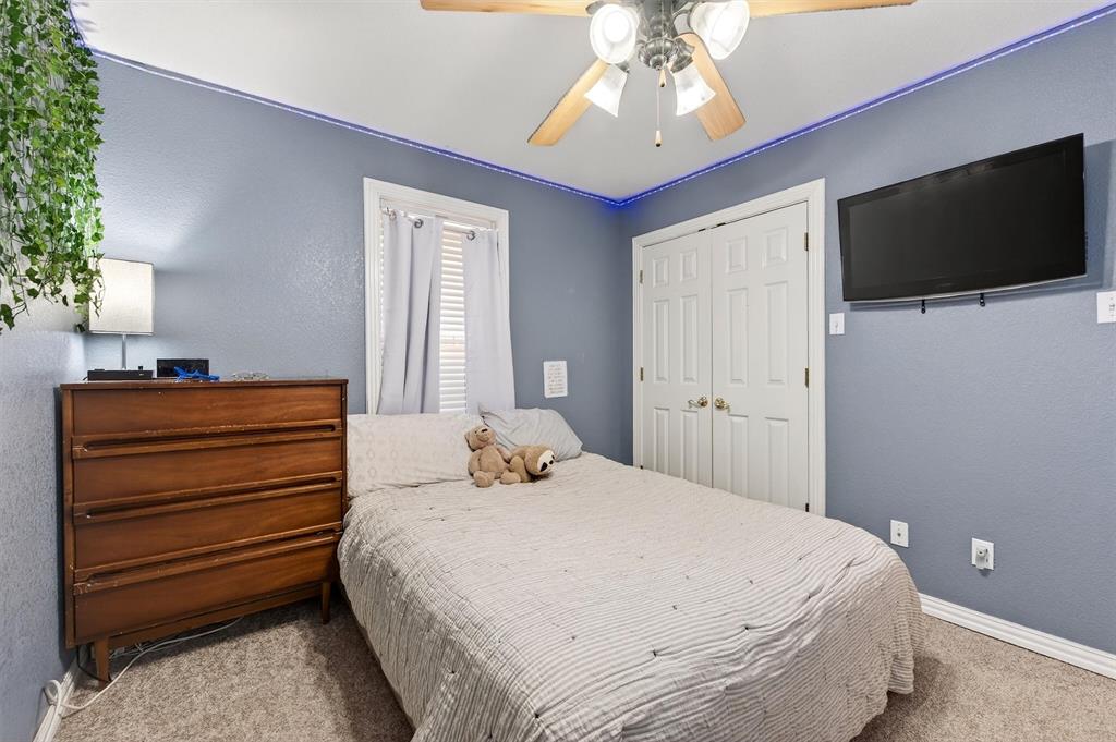 207 Gayle Circle Bells, TX 75414 - Photo 24 of 30 a bedroom with a bed and a flat tv screen on dresser
