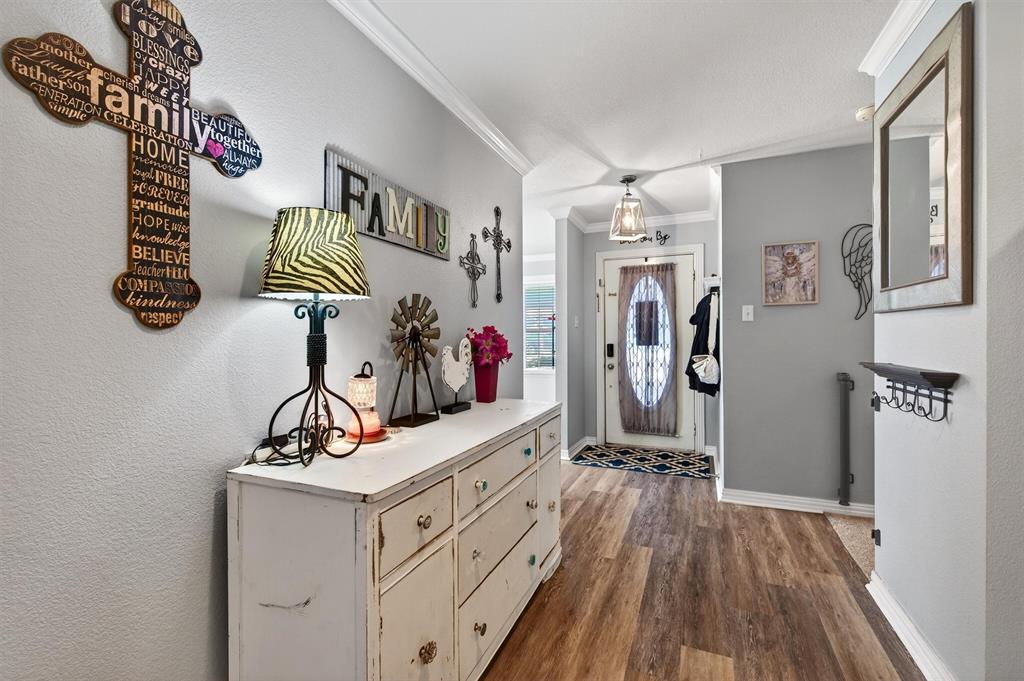 207 Gayle Circle Bells, TX 75414 - Photo 5 of 30 a view of a hallway to room with wooden floor and windows