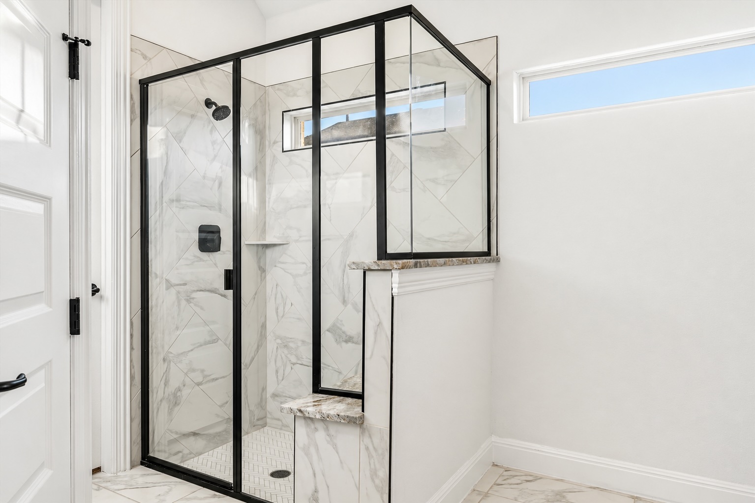 209 Rainier Drive Kyle, TX 78640 - Photo 13 of 24 Glass-enclosed shower featuring black framing, white tile walls with a diagonal pattern, and a built-in bench