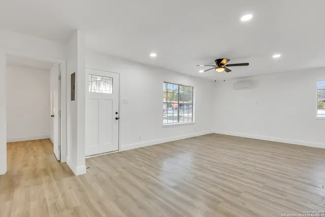 wooden floor in an empty room with a window