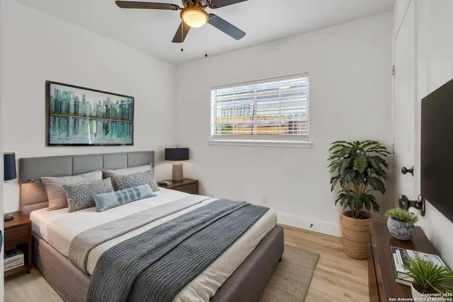 a bedroom with bed and a potted plant