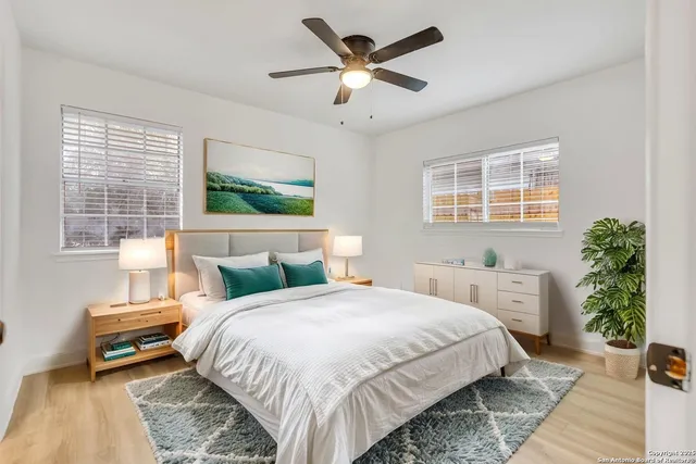 a bedroom with a large bed and a chandelier
