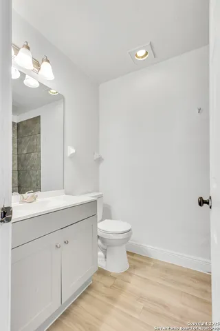 a bathroom with a sink a toilet and a mirror