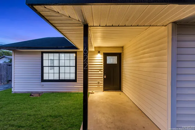 a view of front door of a house with a yard
