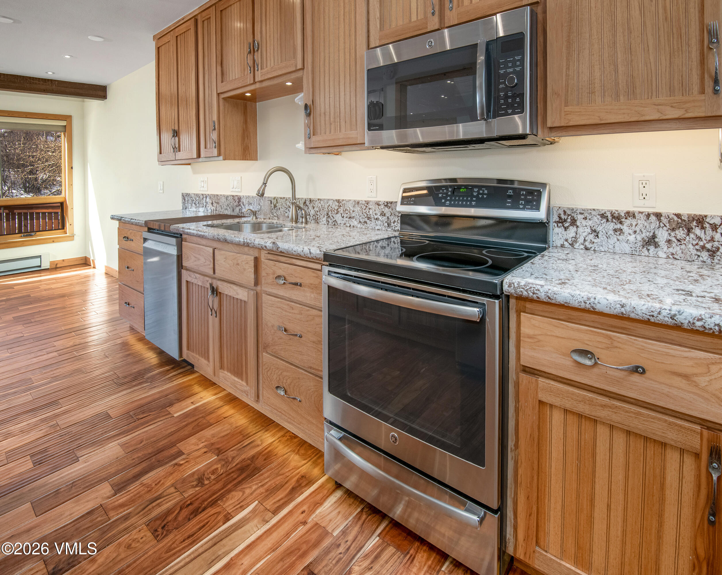 2355 Old Trail Road, Unit 3 Avon, CO 81620 - Photo 11 of 34 a kitchen with stainless steel appliances granite countertop a stove microwave and sink