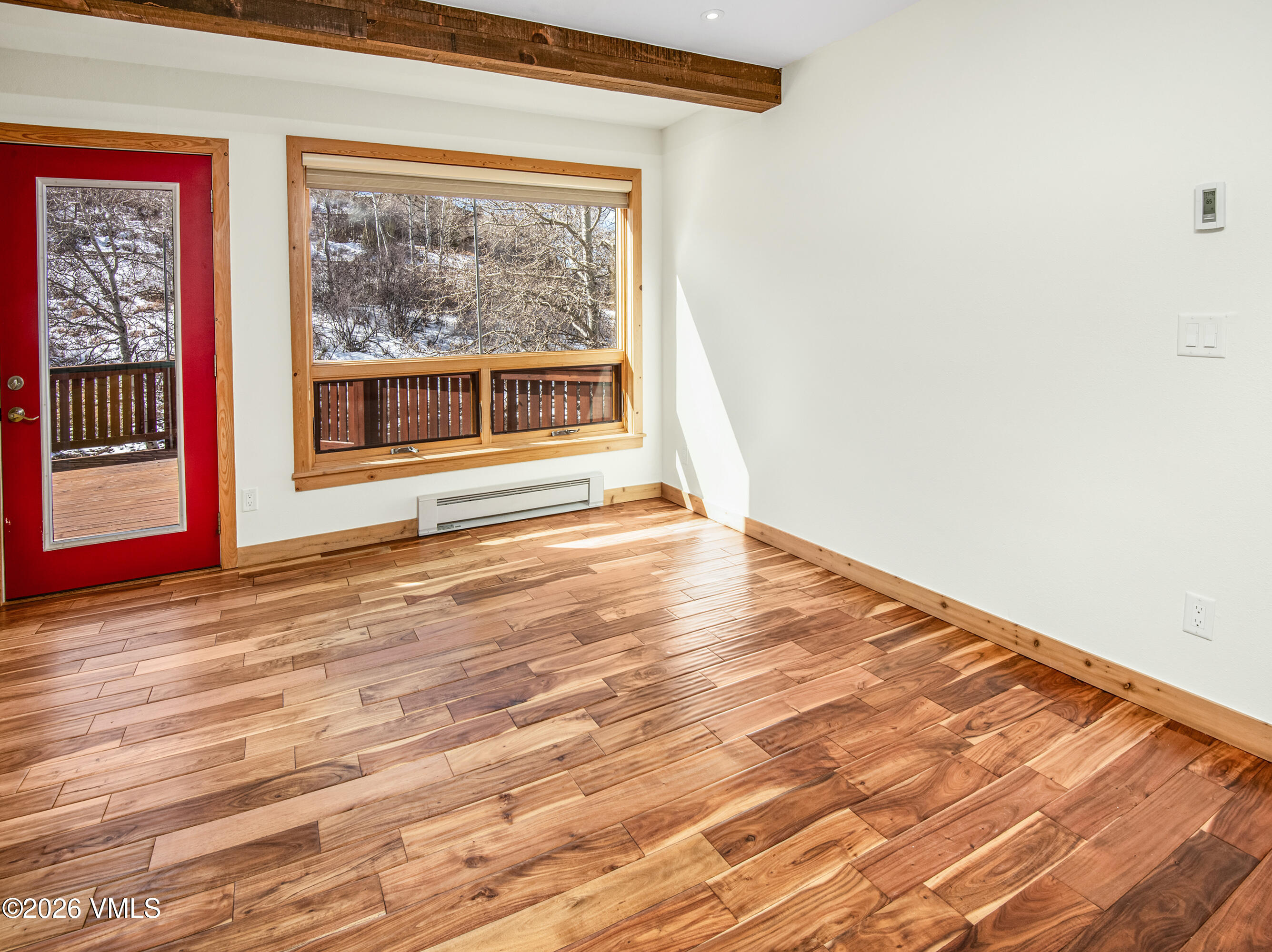 2355 Old Trail Road, Unit 3 Avon, CO 81620 - Photo 13 of 34 a view of an empty room with wooden floor and a window