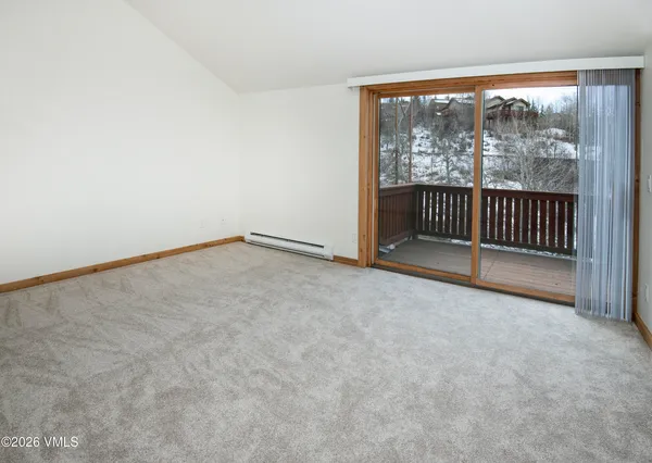 an empty room with floor to ceiling window