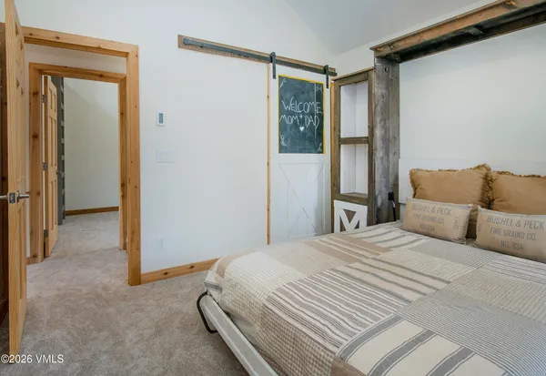 a bedroom with a bed and a mirror