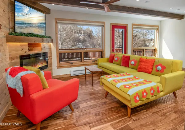a living room with furniture and a floor to ceiling window
