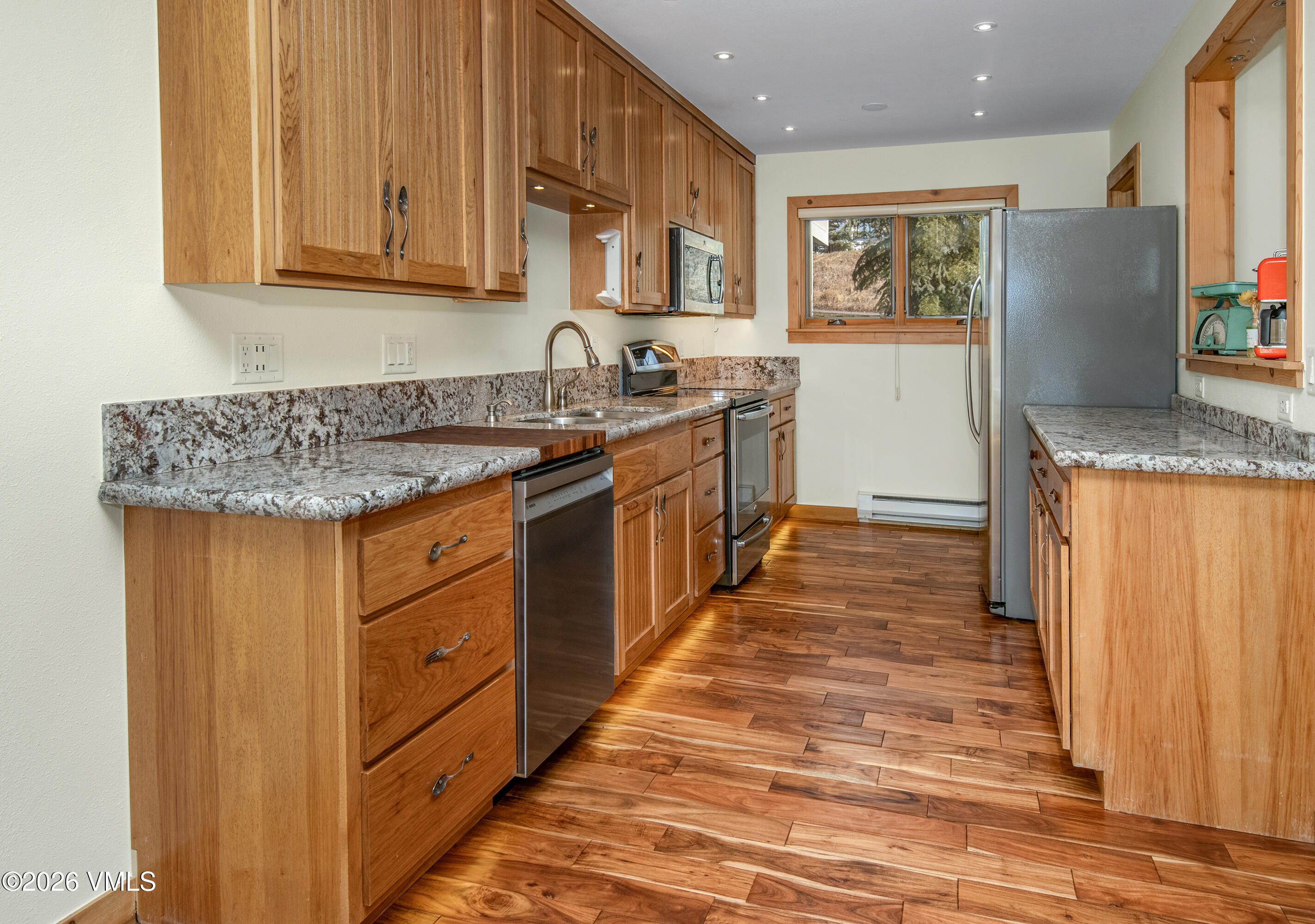 2355 Old Trail Road, Unit 3 Avon, CO 81620 - Photo 7 of 34 a kitchen with stainless steel appliances granite countertop a sink and a refrigerator