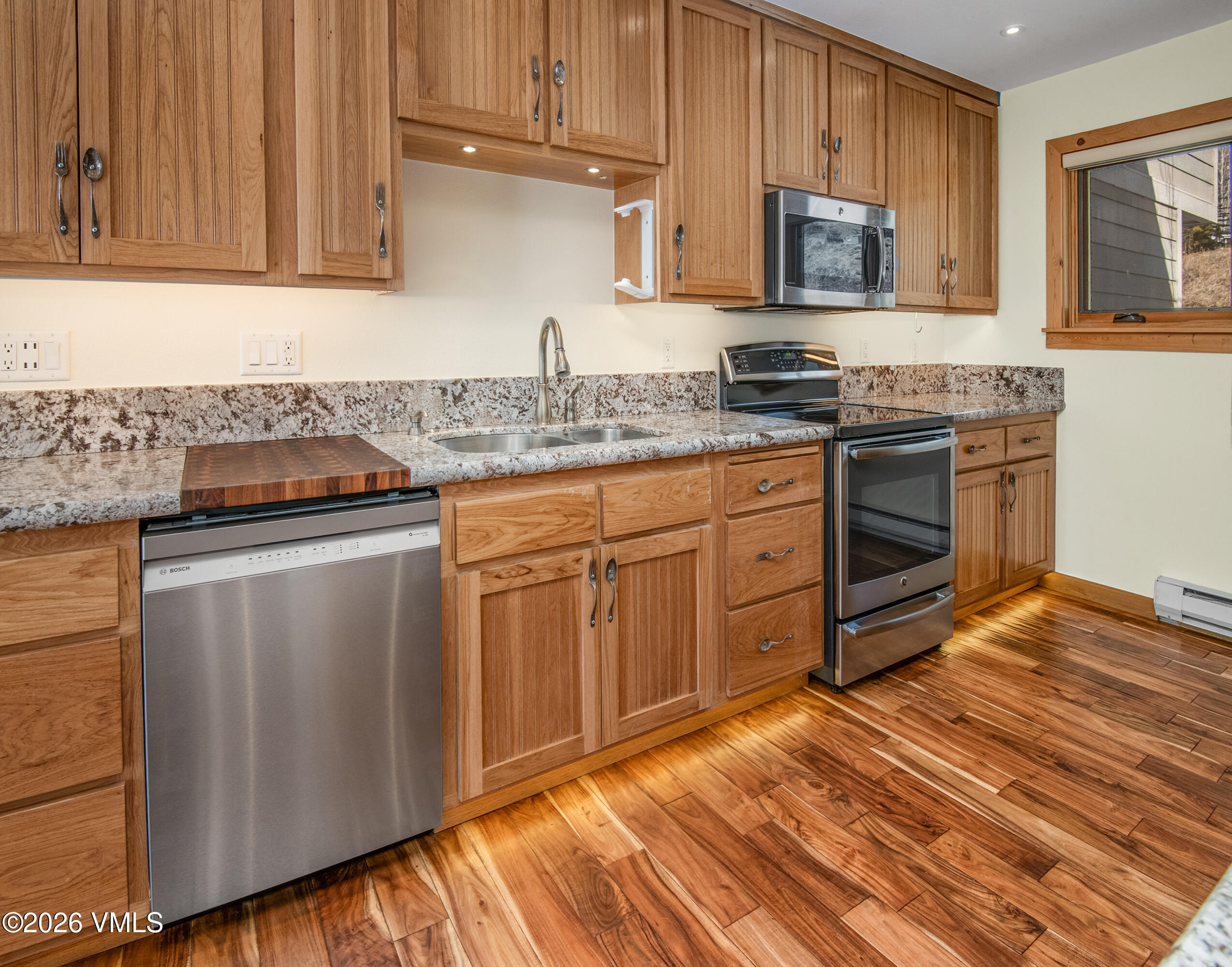 2355 Old Trail Road, Unit 3 Avon, CO 81620 - Photo 8 of 34 a kitchen with stainless steel appliances granite countertop a stove a sink and a microwave