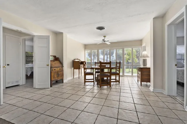 a view of a kitchen with dining area and refrigerator