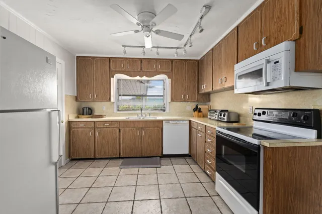 a kitchen with a stove sink and refrigerator