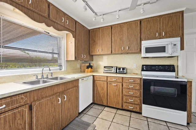 a kitchen with a sink stove and microwave