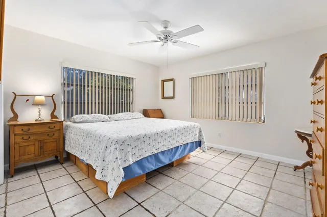 a spacious bedroom with a bed and window