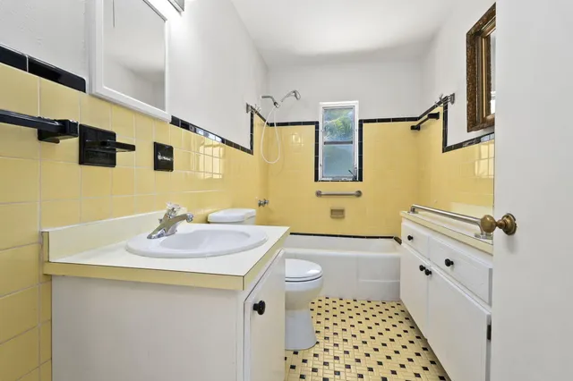 a bathroom with a sink a tub and a mirror