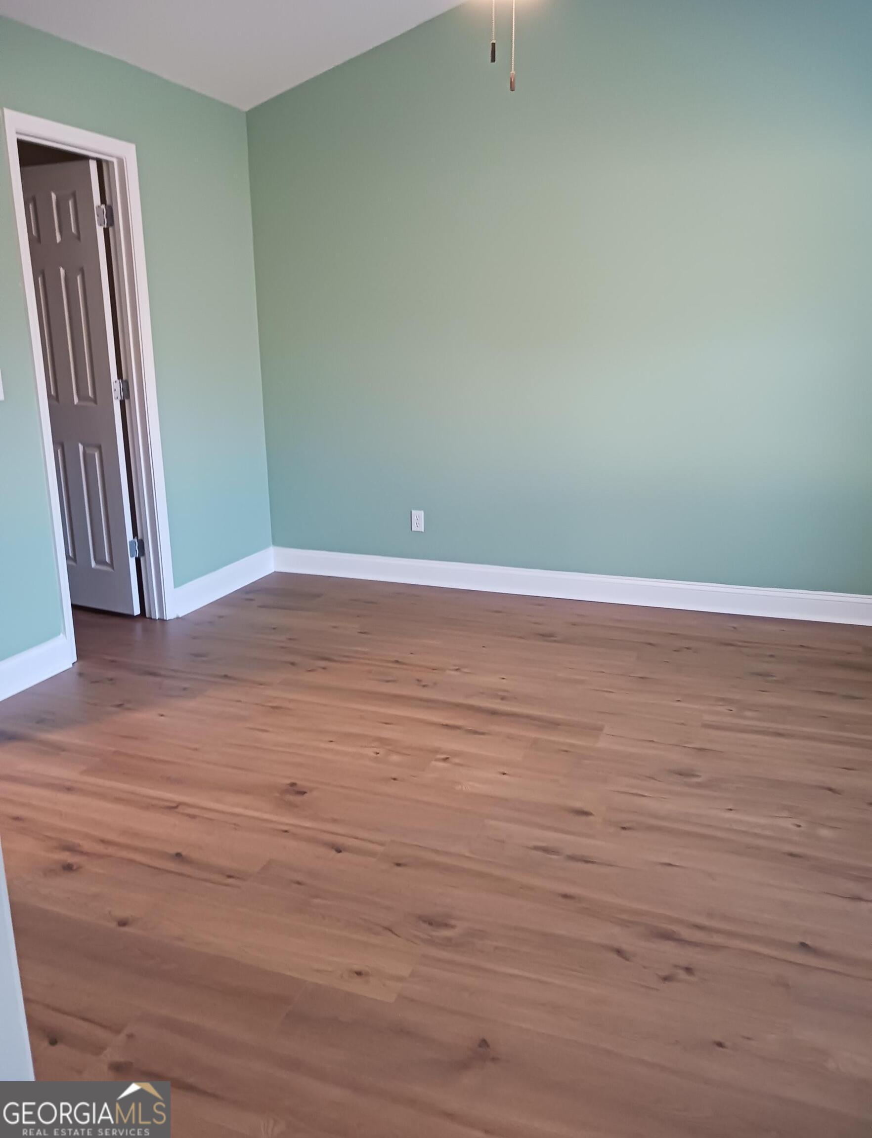 907 Downing Drive Bethlehem, GA 30620 - Photo 15 of 26 a view of an empty room with wooden floor