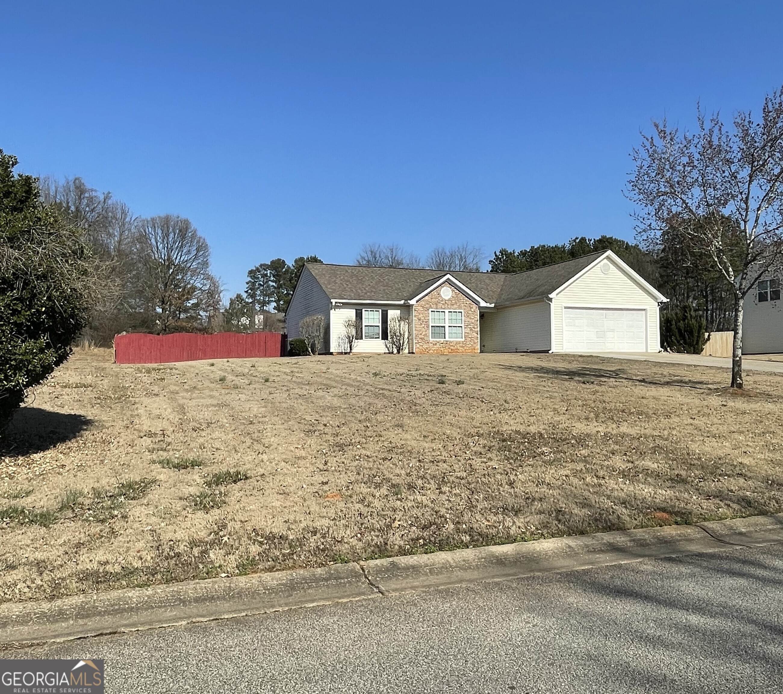 907 Downing Drive Bethlehem, GA 30620 - Photo 2 of 26 a view of wooden house with a yard and large trees
