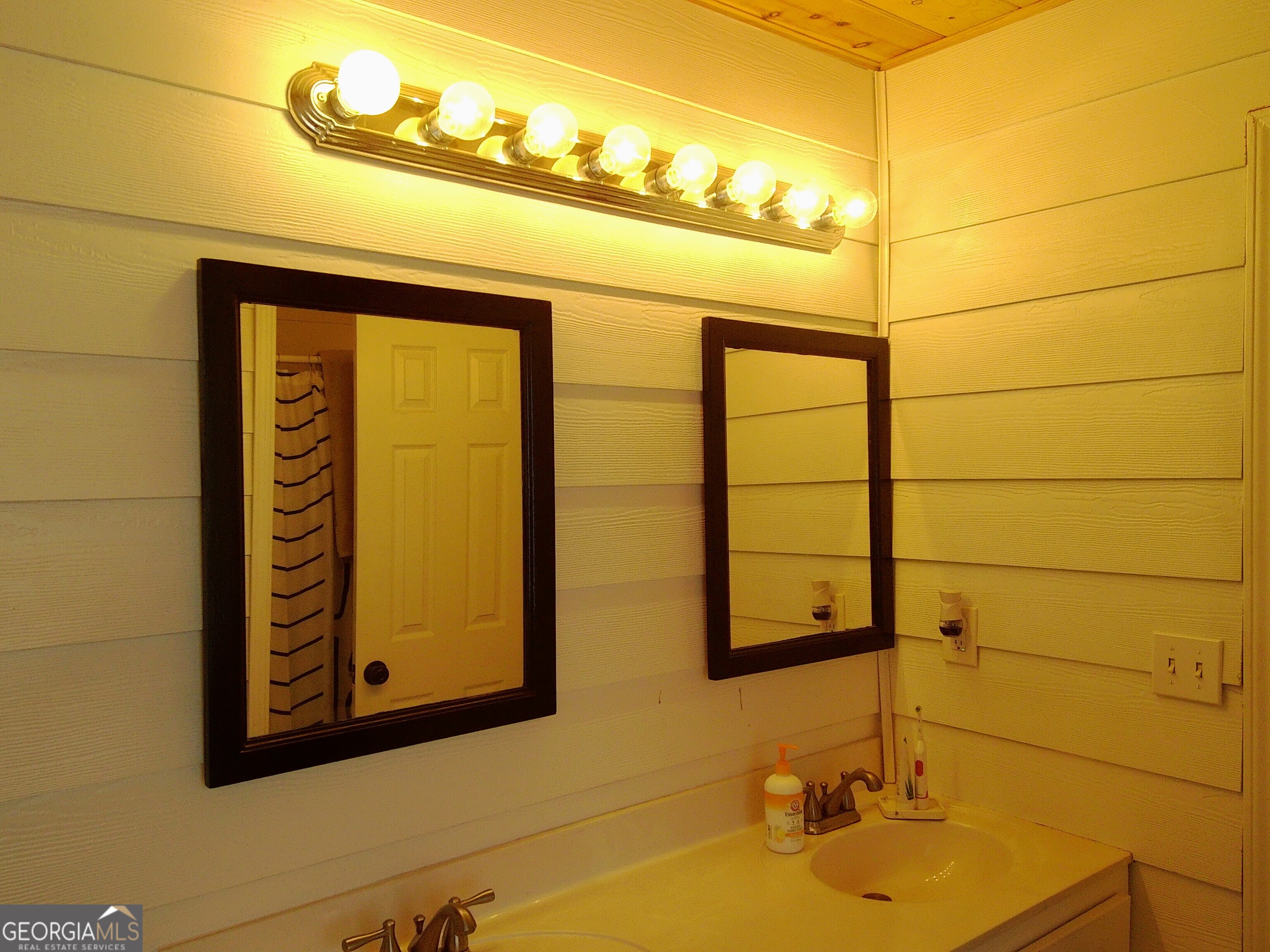 907 Downing Drive Bethlehem, GA 30620 - Photo 25 of 26 a bathroom with a sink and a mirror