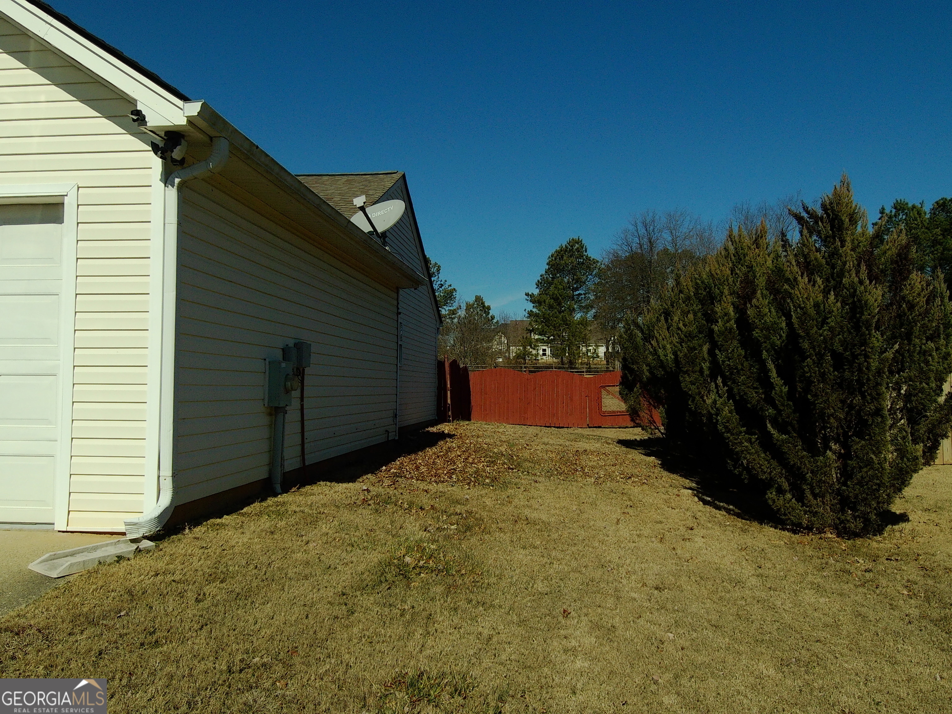 907 Downing Drive Bethlehem, GA 30620 - Photo 3 of 26 a backyard of a house with wooden fence