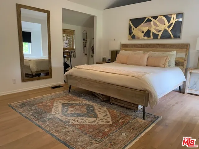 a bedroom with a bed and a dresser