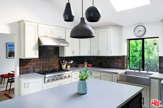 a kitchen with a stove a microwave and a sink