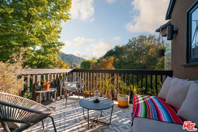 a view of a chair and tables on the roof deck