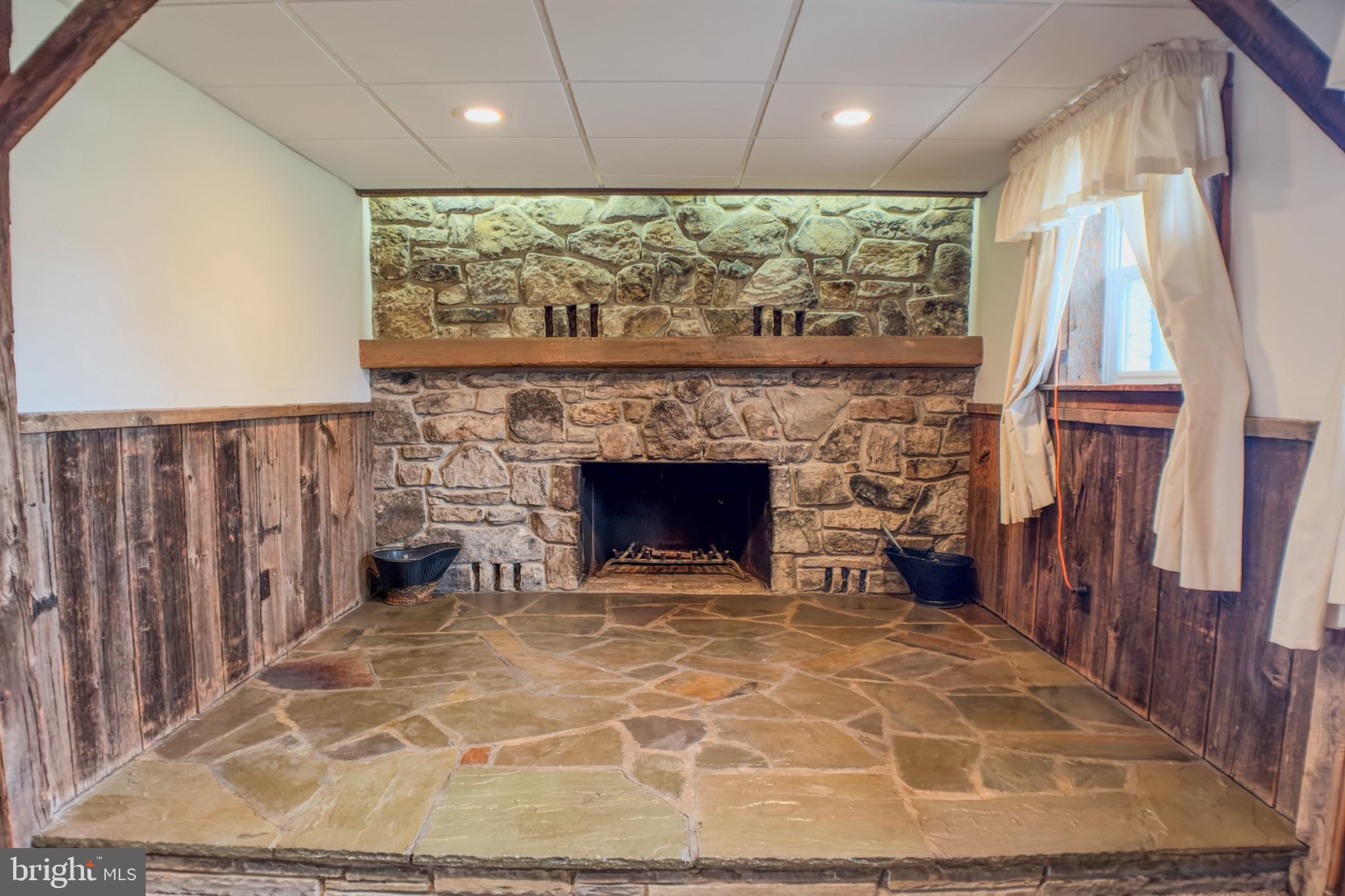 467 Swanger Road New Columbia, PA 17856 - Photo 5 of 45 a view of an empty room with a fireplace and a window