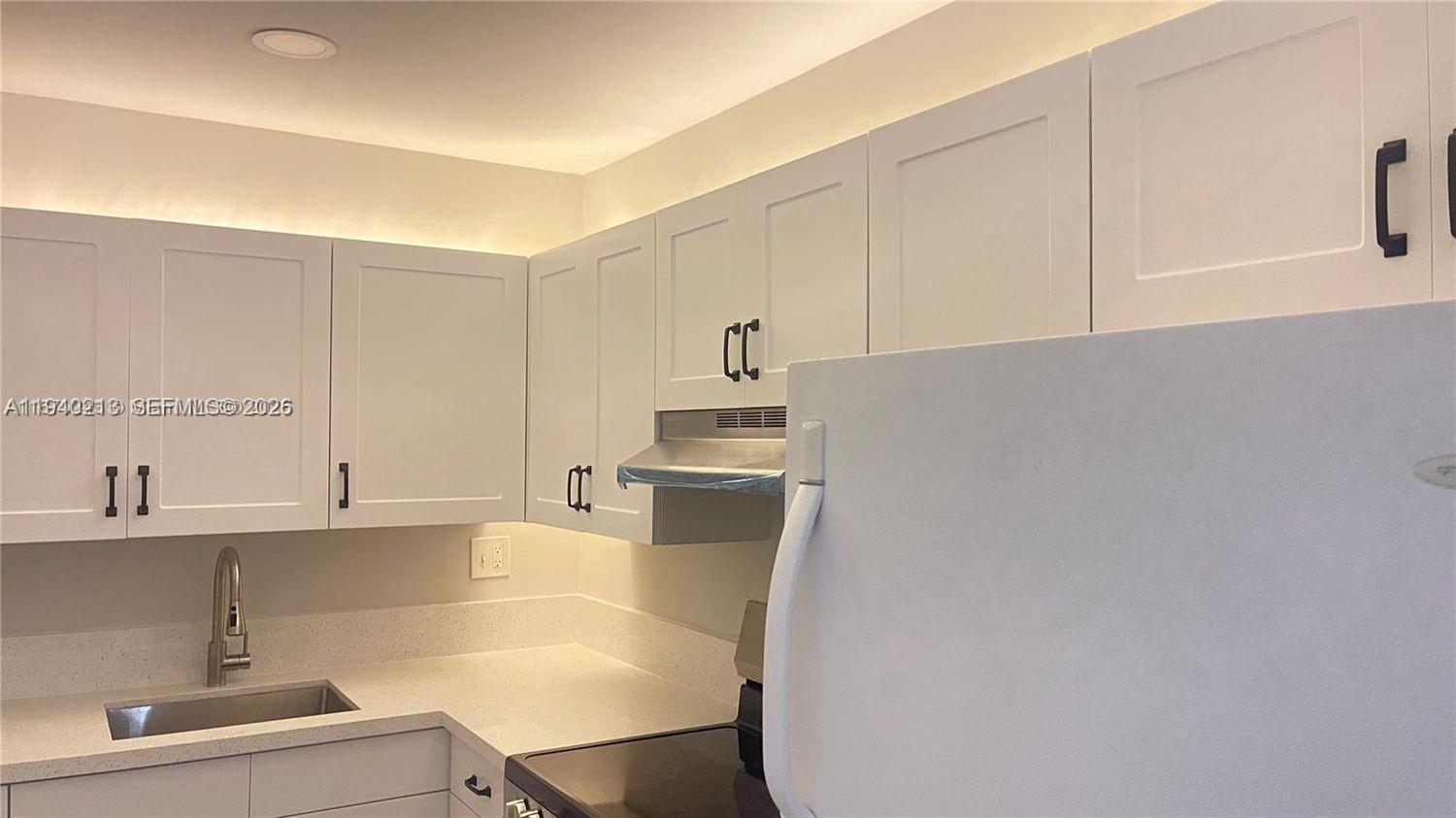 200 South Birch Road, Unit 702 Fort Lauderdale, FL 33316 - Photo 8 of 19 a kitchen with a sink cabinets and window