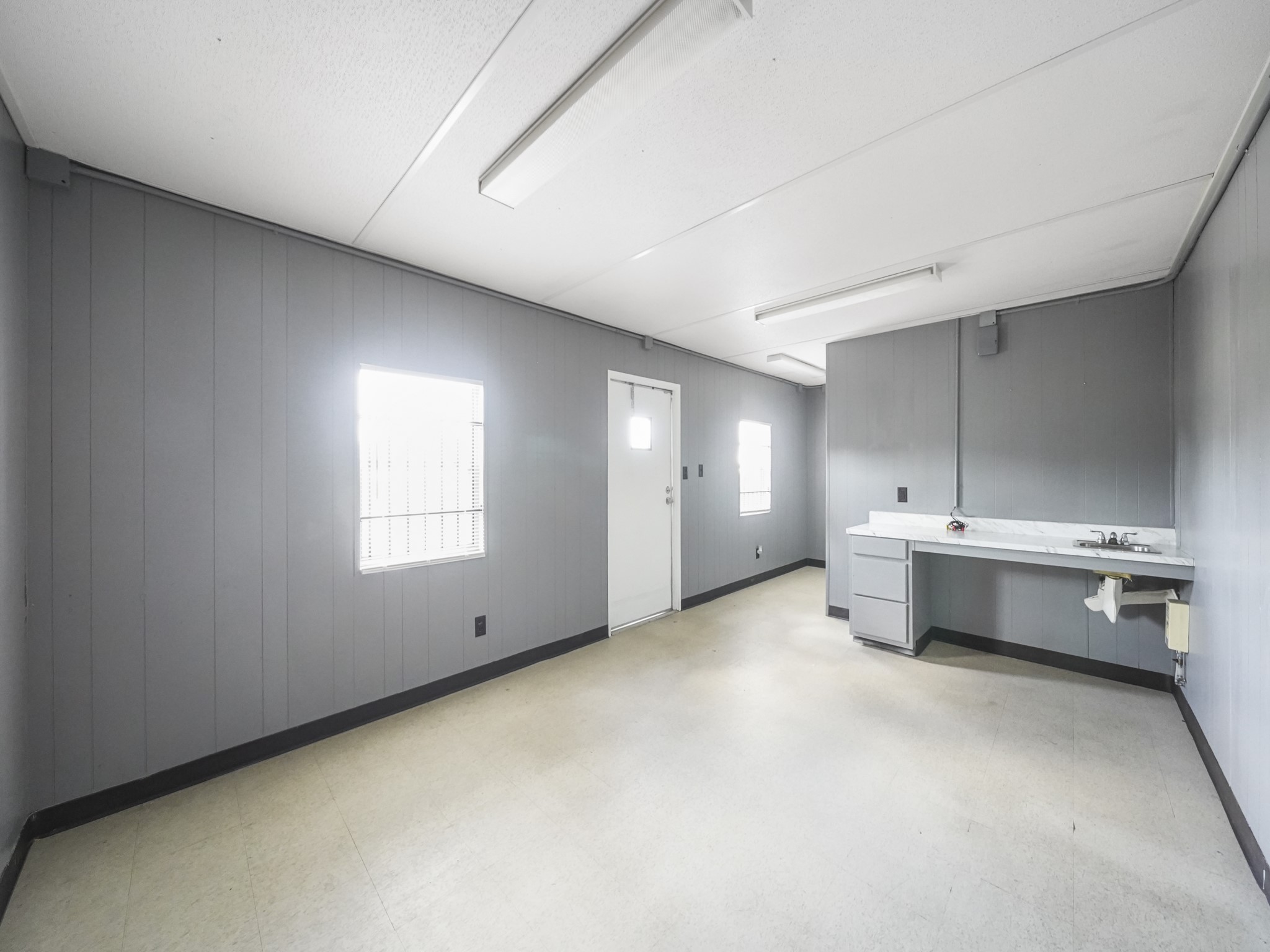 803 North Loop Houston, TX 77022 - Photo 13 of 16 an empty room with a cabinet and mirrors