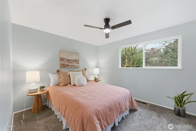 a bedroom with a bed and a potted plant